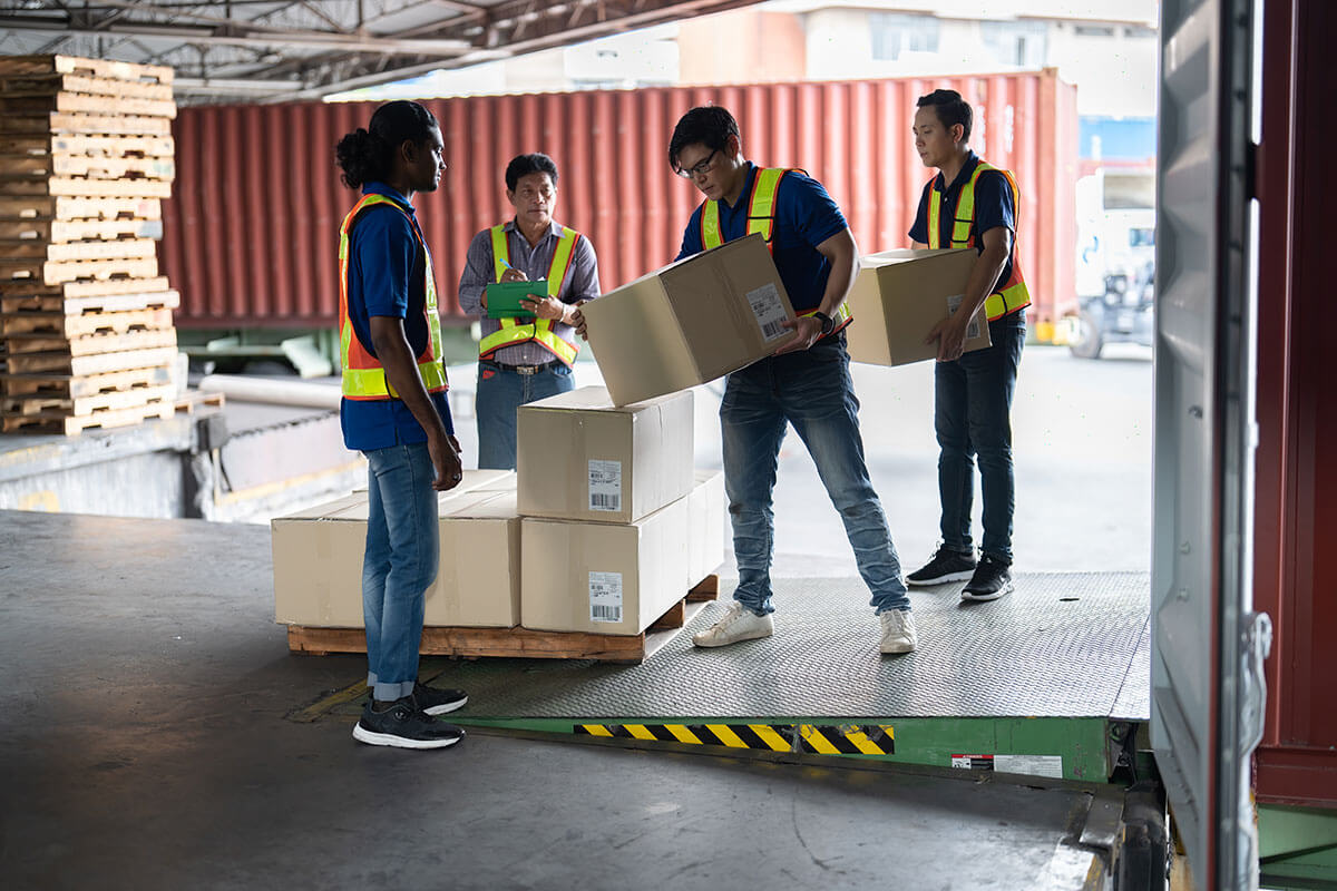 Image of warehouse workers moving boxes and pallets