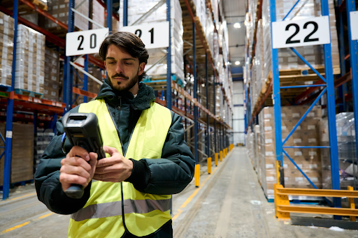 Image of a Ship Central warehouse worker checking information on his scanner